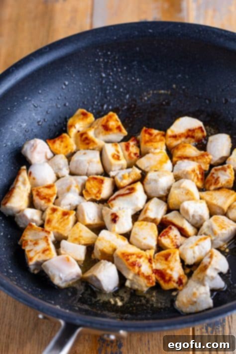 Velvety Chicken and Mushroom Feast 11 A skillet with cooked, diced chicken.