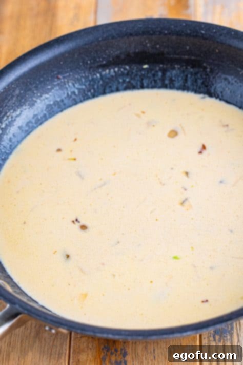 Velvety Chicken and Mushroom Feast 15 A creamy sauce in a skillet.