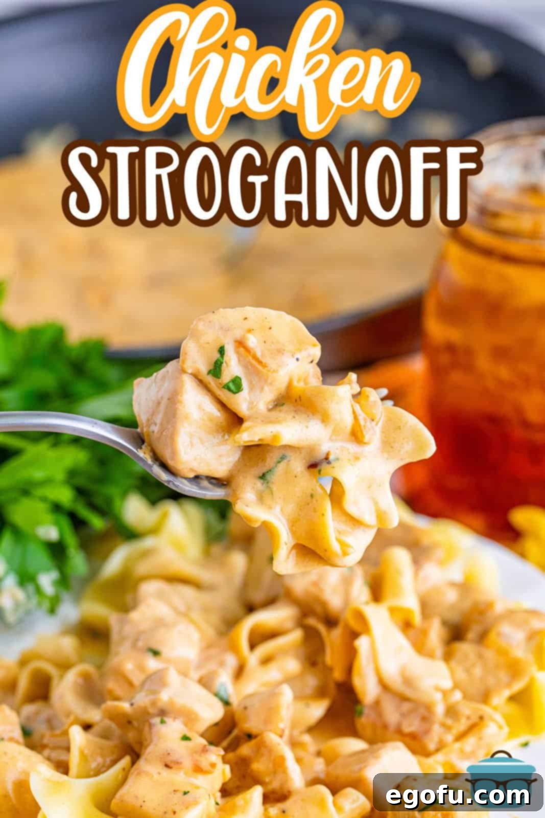 Velvety Chicken and Mushroom Feast 3 A fork lifting a piece of chicken and creamy sauce from a plate of Chicken Stroganoff, highlighting its texture.