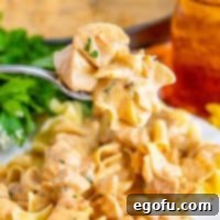 Velvety Chicken and Mushroom Feast 10 Close up looking at a fork holding a bite of Chicken Stroganoff.