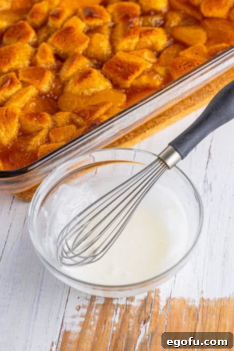 whisking together powdered sugar and milk in a bowl.