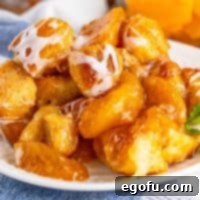 Closely looking at a dessert plate with a serving of Peach Dumpling Bubble Up.
