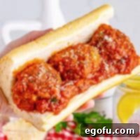 Hand-Rolled Meatballs 11 A sub roll with Homemade Meatballs and sauce on it.