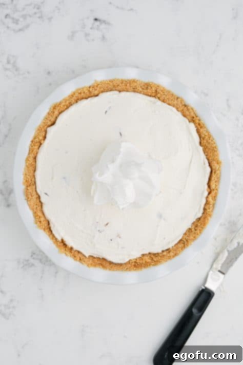 Whipped topping spread out over the pie filling.