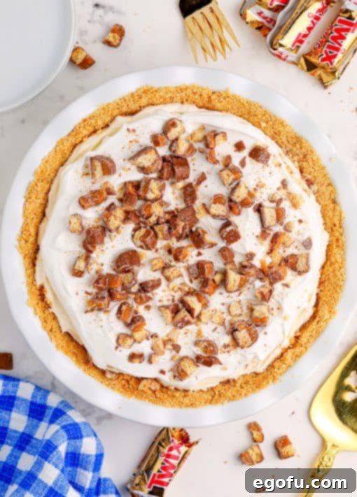 A No Bake Twix Pie with chopped Twix on top.