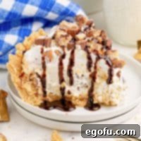 A small white serving plate with a slice of No Bake Twix Pie.