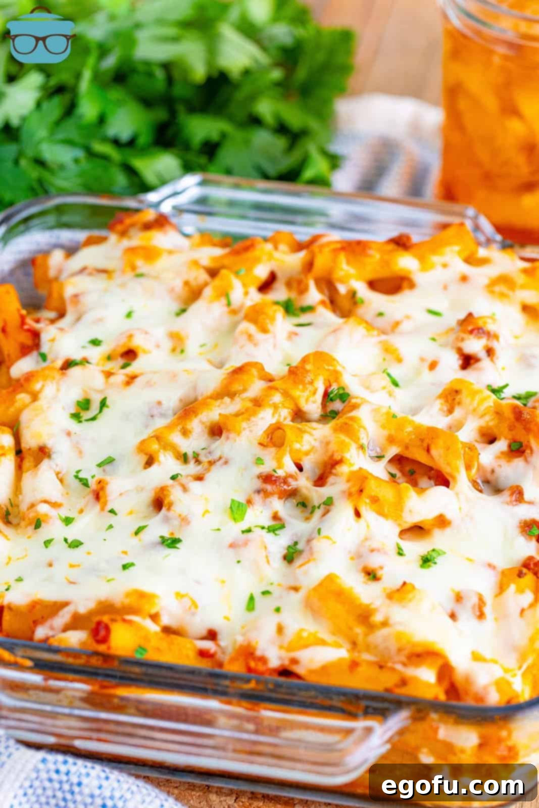 Freshly baked ziti in a glass casserole dish, golden and bubbly.