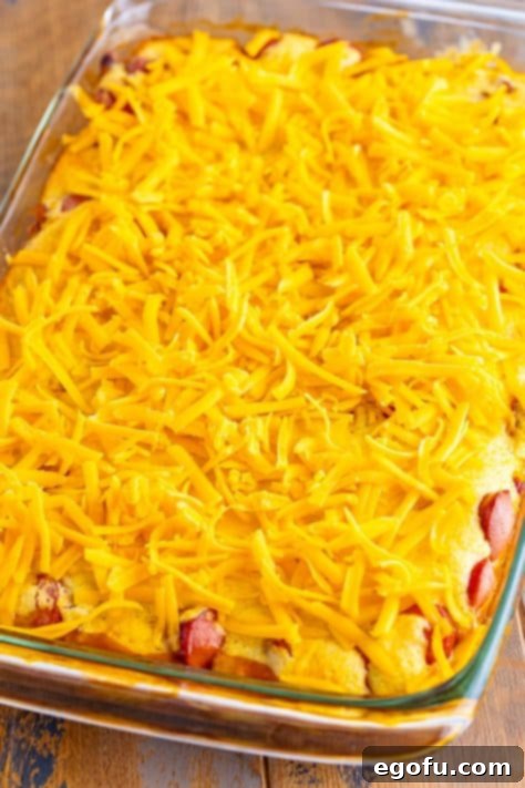 Cheese on top fo Beanie Weenie Casserole in a baking dish.