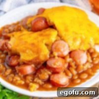 Close up looking down on a plate with a large serving of Beanie Weenie Casserole.
