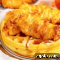 Close up looking at Buttermilk Waffles and crispy fried chicken.