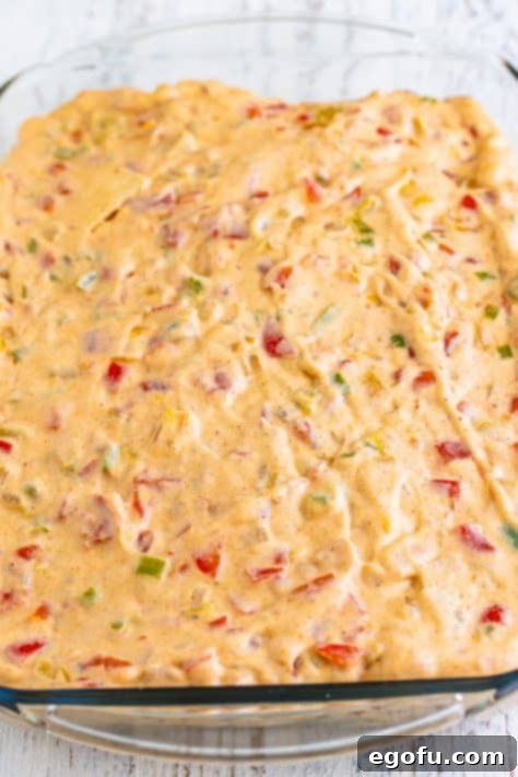 sauce layered on top of tortillas in casserole dish.