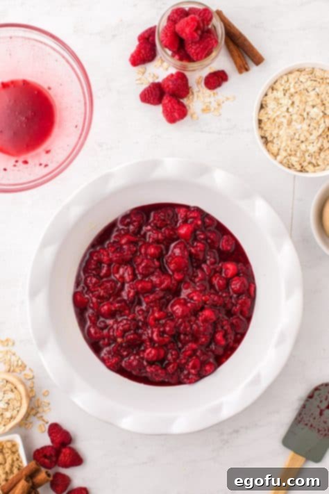 Raspberry filling in a prepared pie plate.