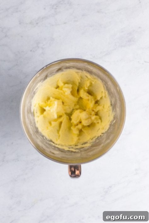 Butter and sugar creamed together in a mixing bowl.