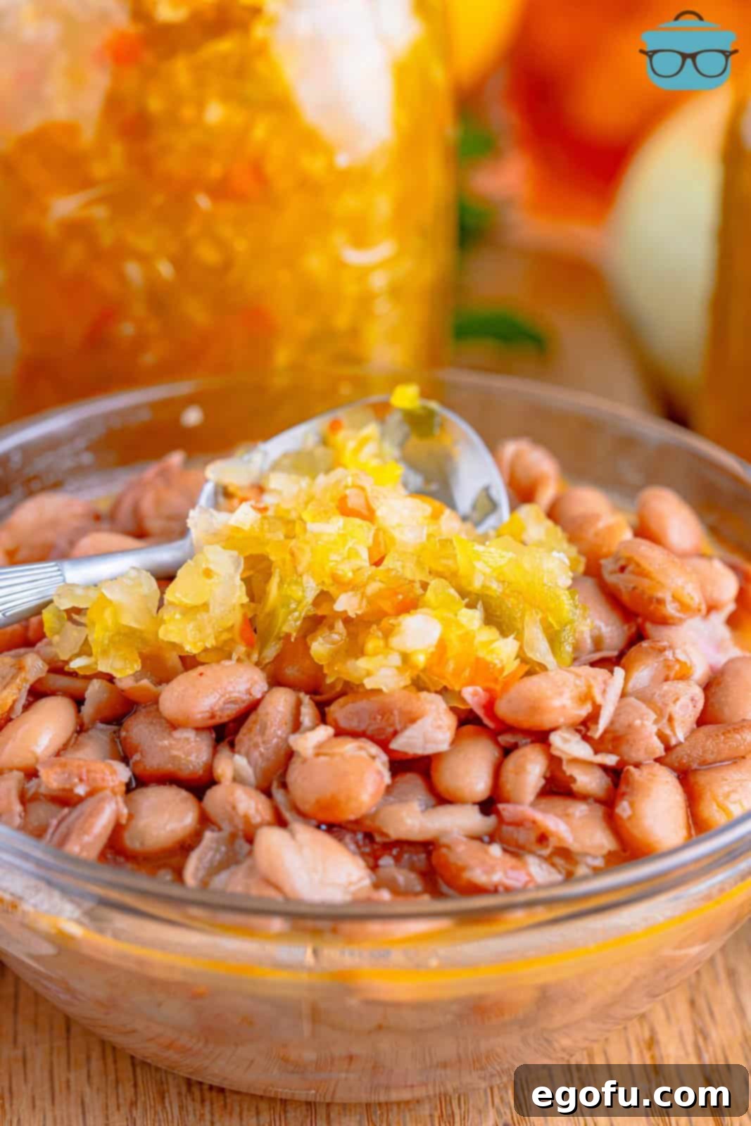 A small glass bowl of Chow Chow with a spoon on top.