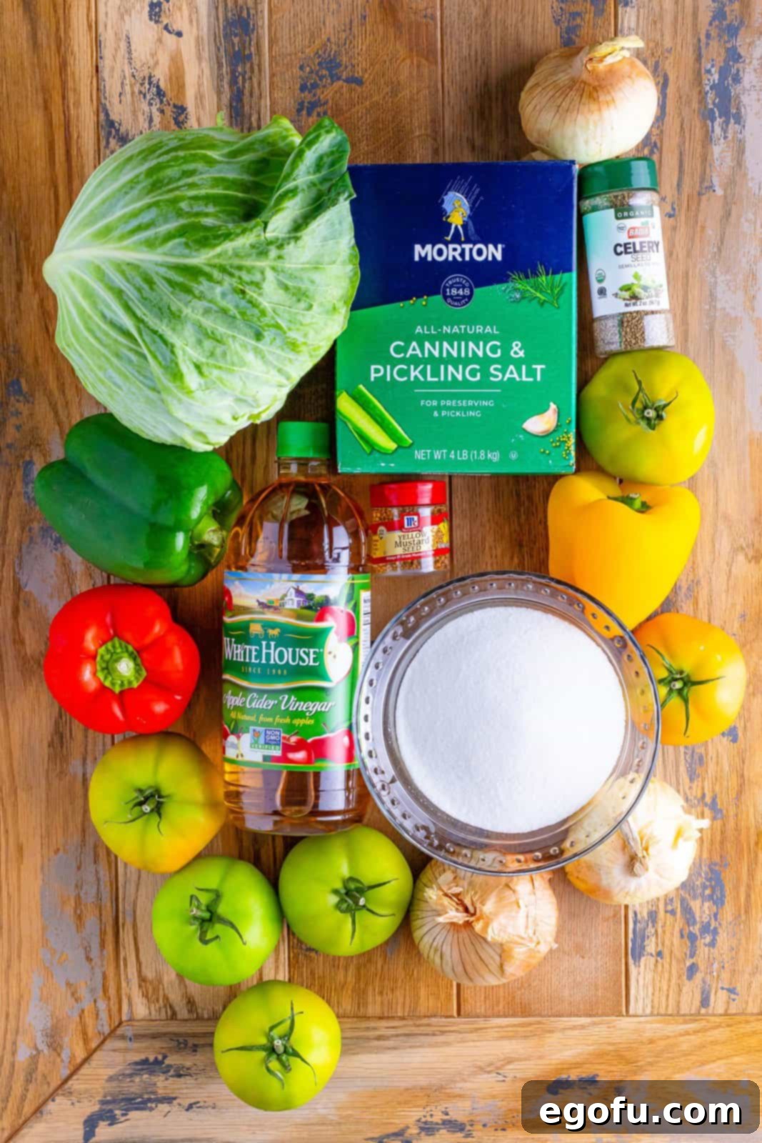 Green tomatoes, sweet onions, green bell pepper, red bell pepper, yellow bell pepper, green cabbage, pickling salt, apple cider vinegar, granulated sugar, mustard seeds, and celery seeds.