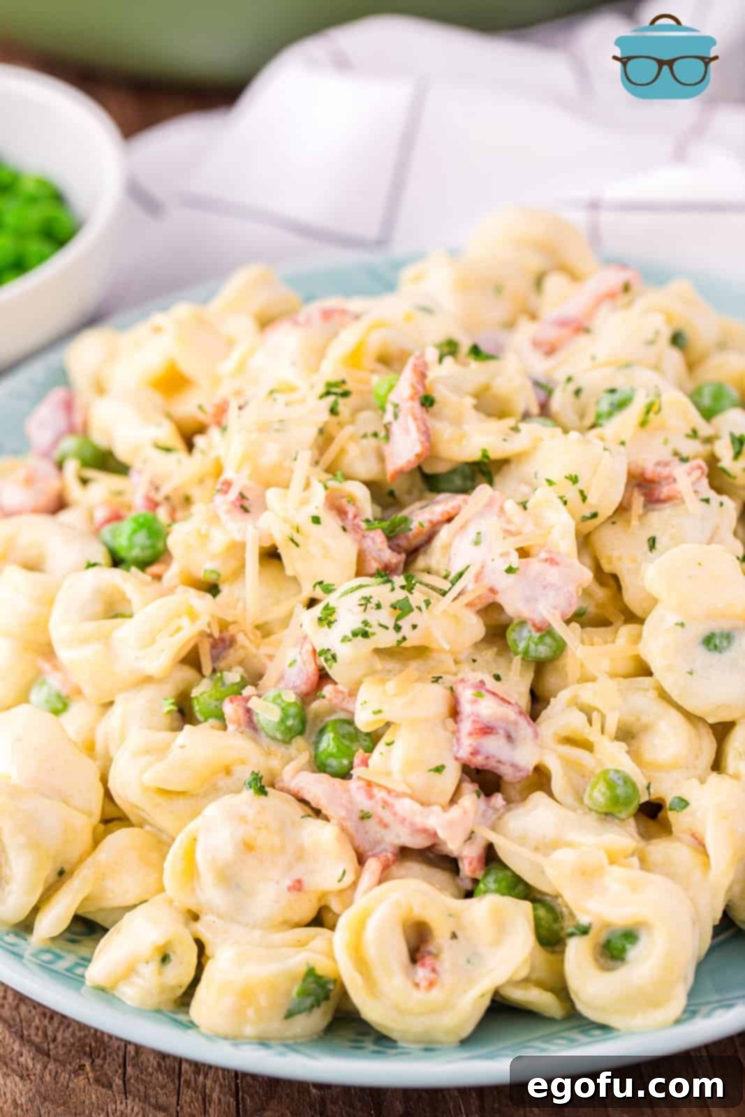 A large plate of Tortellini Carbonara, showcasing its creamy texture and rich ingredients.