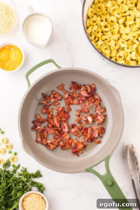 cooked bacon pieces in a skillet.