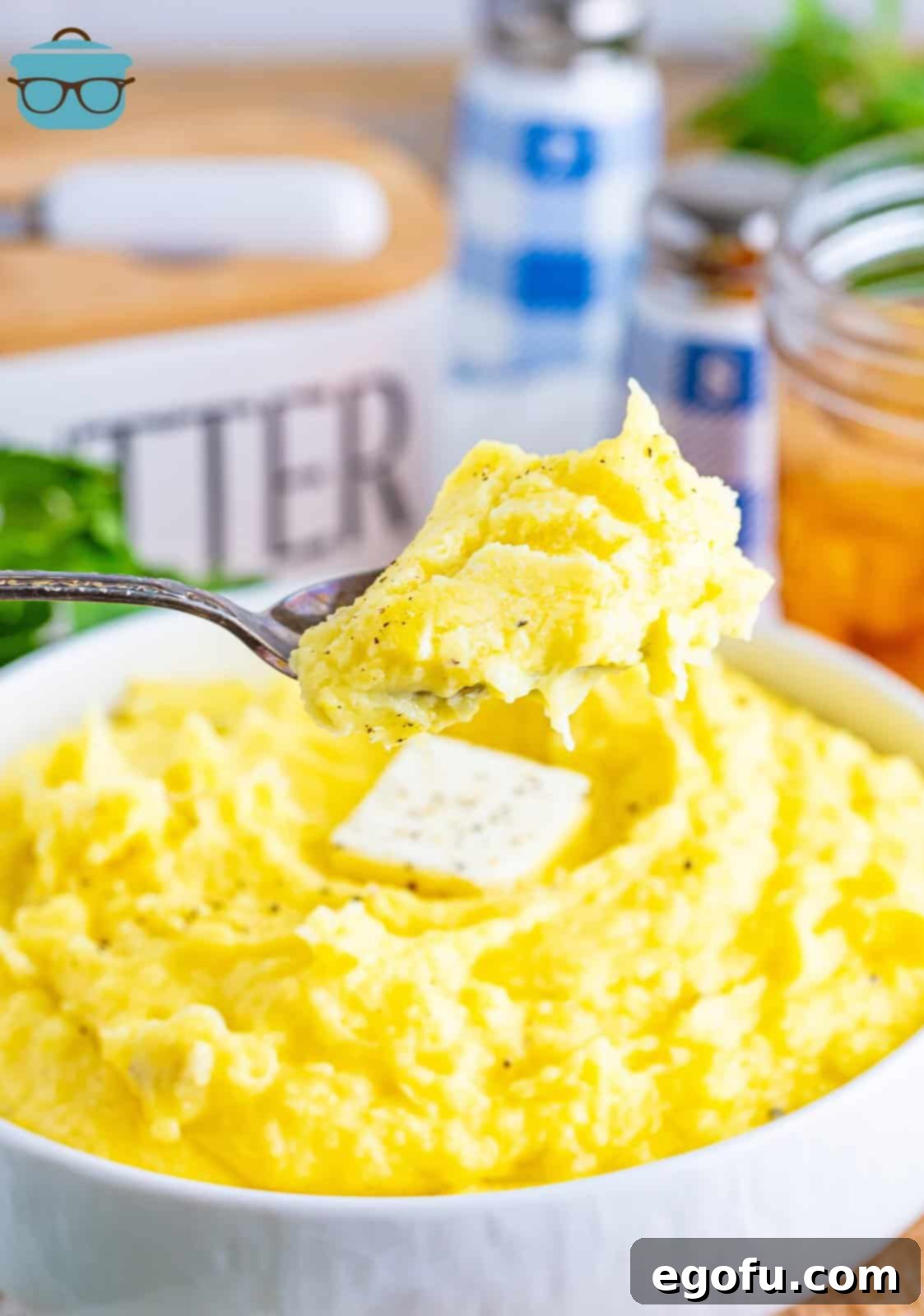 Velvety Stovetop Mashed Potatoes 2 A serving utensil holding a bite of creamy Stovetop Mashed Potatoes, showcasing their fluffy and smooth texture.