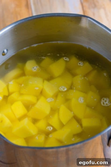 Velvety Stovetop Mashed Potatoes 5 A pot of uniformly diced potatoes perfectly covered with cold water, ready for the boiling process.