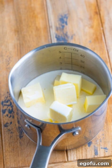 Velvety Stovetop Mashed Potatoes 6 Cubes of butter, savory chicken stock, and rich heavy cream combined in a small saucepot, warming gently on the stovetop.