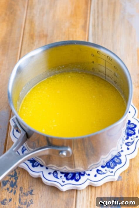 Velvety Stovetop Mashed Potatoes 7 The butter, chicken stock, and cream mixture fully melted and uniformly warm in a saucepot, perfectly ready to be added to the cooked potatoes.