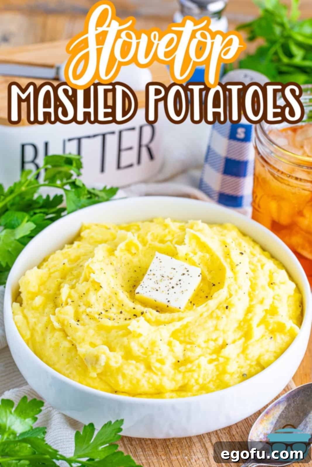 Velvety Stovetop Mashed Potatoes 3 A large bowl of Stovetop Mashed Potatoes, beautifully garnished with fresh chives and a pat of melting butter, ready to be served.