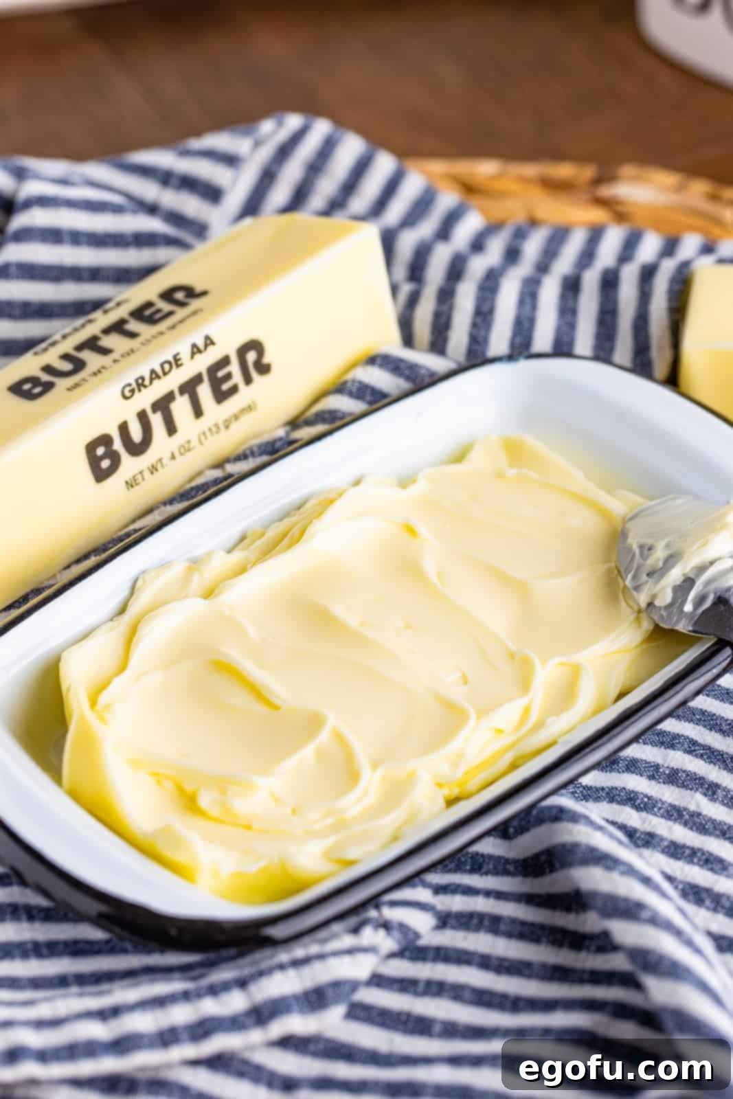 Smoothed out butter in a dish, showing its softened state after microwave treatment.