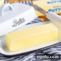 A softened stick of butter on a butter tray, perfectly ready for use.