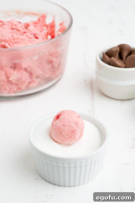 Sakura Bloom Bites 13 A round ball of Cherry Blossom Cookie dough in a ramekin of granulated sugar.