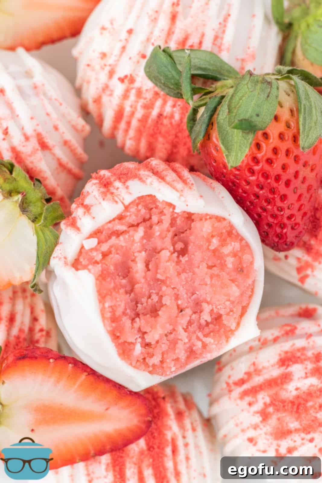 Decadent Strawberry Cake Bites 2 Looking down on a few Strawberry Cake Balls, one missing a bite.