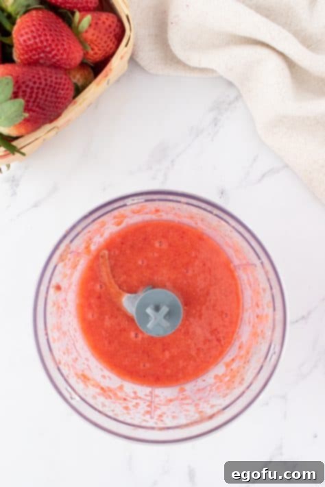 Decadent Strawberry Cake Bites 11 Pureed strawberries in a food processor bowl.