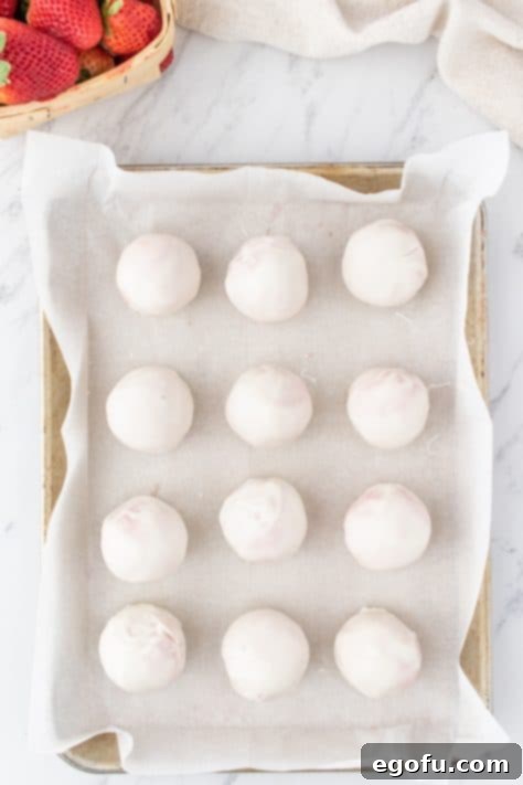 Decadent Strawberry Cake Bites 19 Strawberry Cake Balls dipped in white chocolate to make Strawberry Truffles.