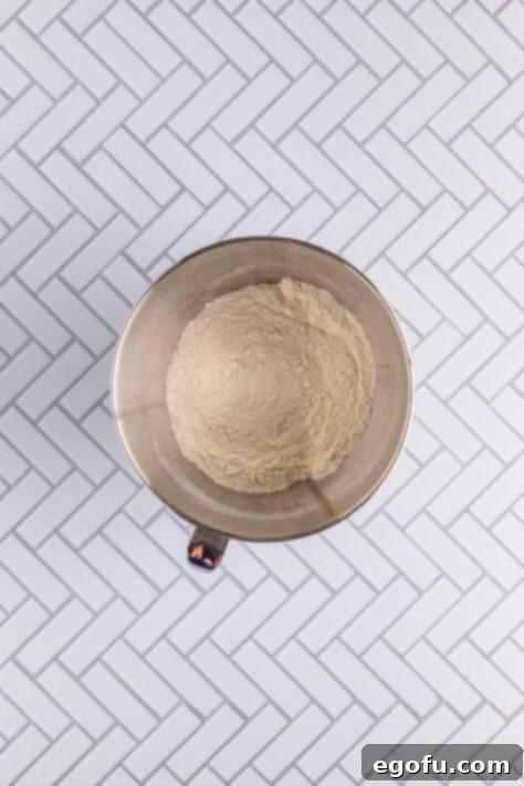 Festive Confetti Cupcakes 12 A mixing bowl with flour, sugar, baking powder, and baking soda, perfectly combined.