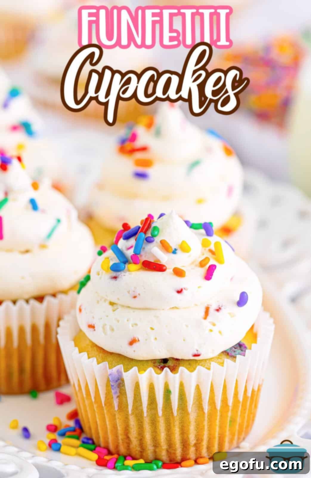 Festive Confetti Cupcakes 3 Closer looking at a couple vanilla Funfetti Cupcakes, showing the vibrant sprinkles within the cake and the creamy frosting swirls, ready to be eaten.