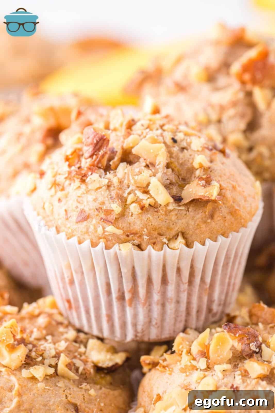 Closely looking at a Banana Nut Cake Mix Muffin sitting on top of a few others.