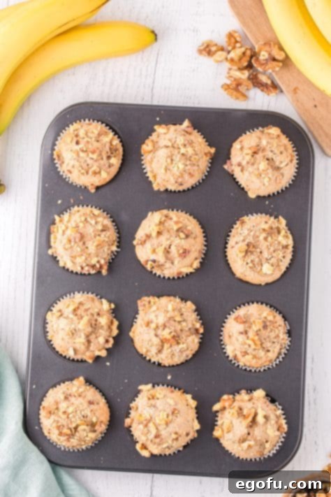 Fresh baked Banana Nut Cake Mix Muffins in the muffin tin cooling.