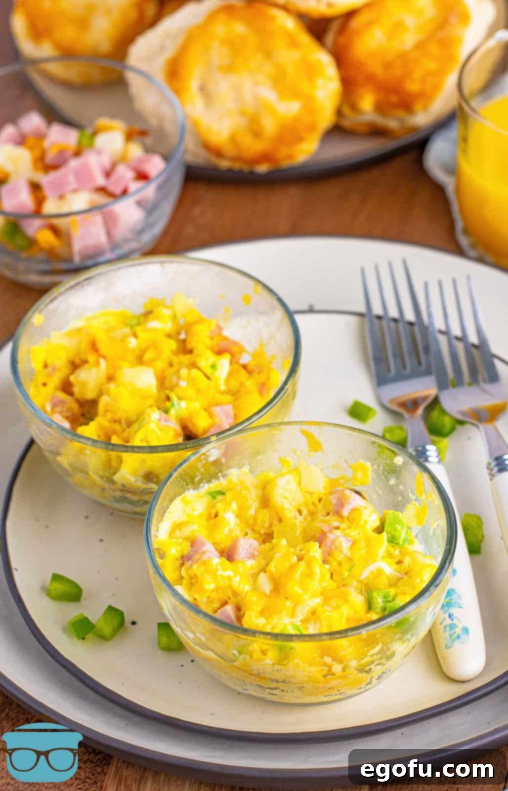 Two small microwave bowls with perfectly cooked Microwave Scrambled Egg Cups, ready to be enjoyed.