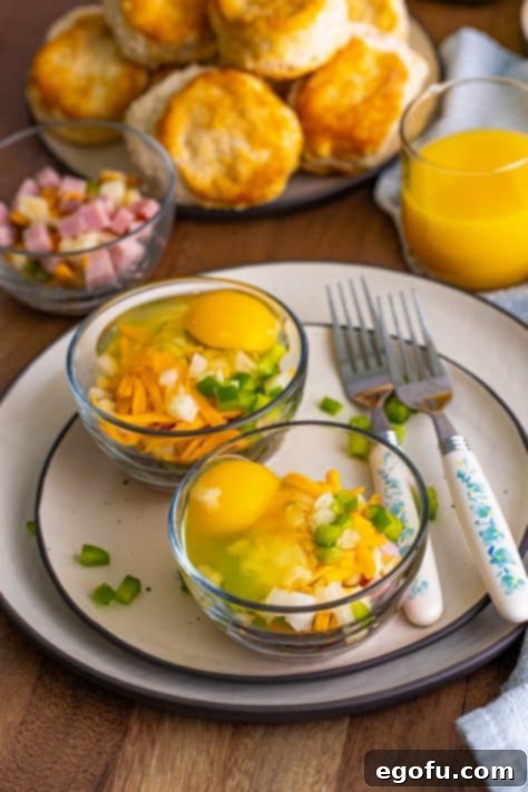 Raw egg with onion, bell pepper, cheese, potato, and ham in a small microwave safe bowl, ready to be mixed.