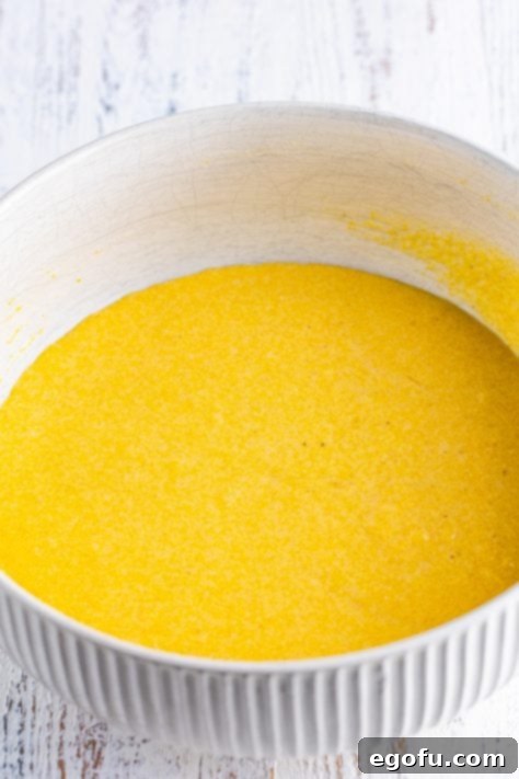 Golden Corn Muffins 11 A mixing bowl with cornbread muffin batter in it.