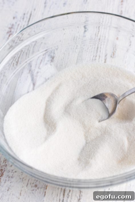 Sugar and flour in a mixing bowl.