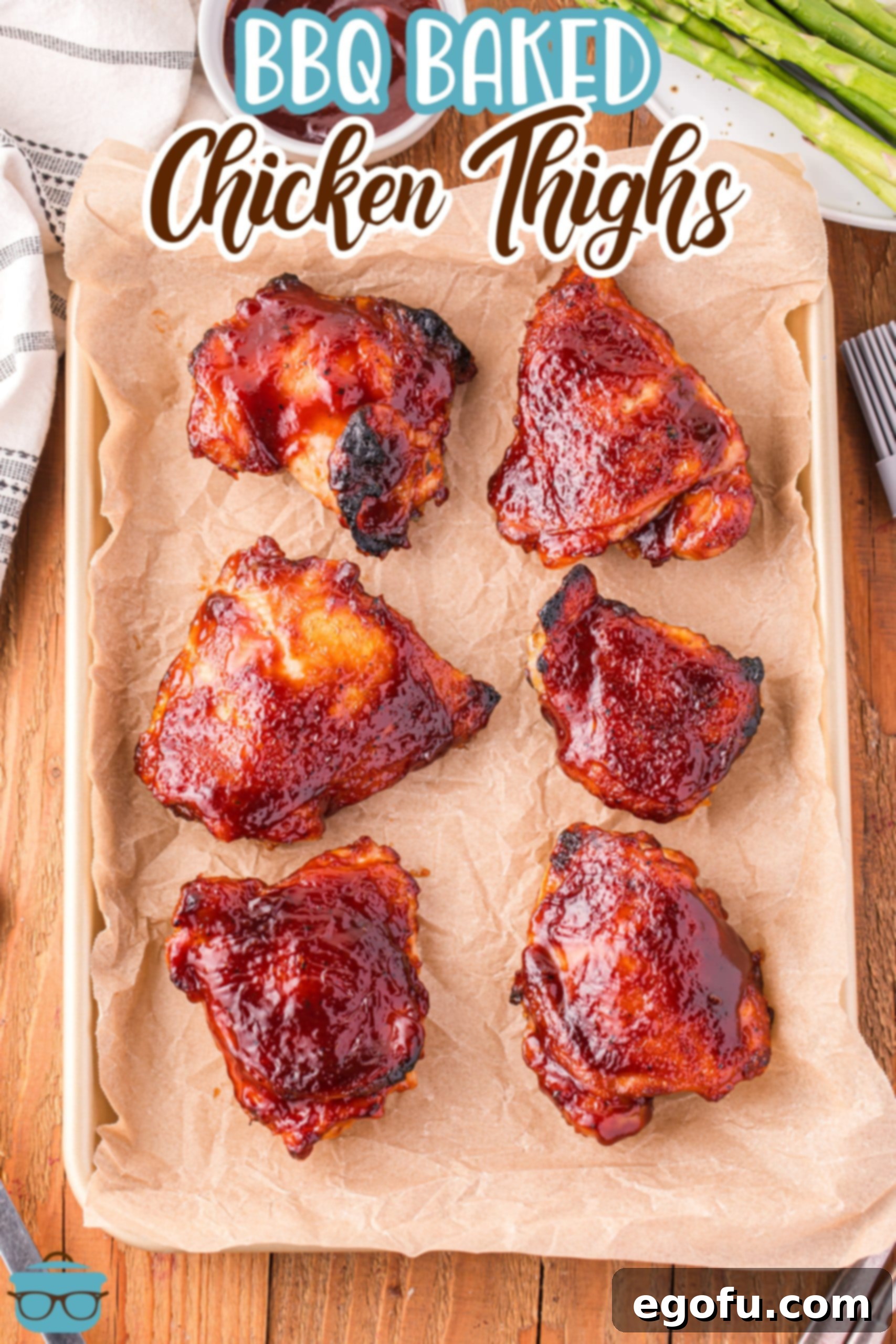 Smoky Barbecue Roasted Chicken Thighs 3 Looking down on a parchment lined baking sheet with BBQ Baked Chicken Thighs.