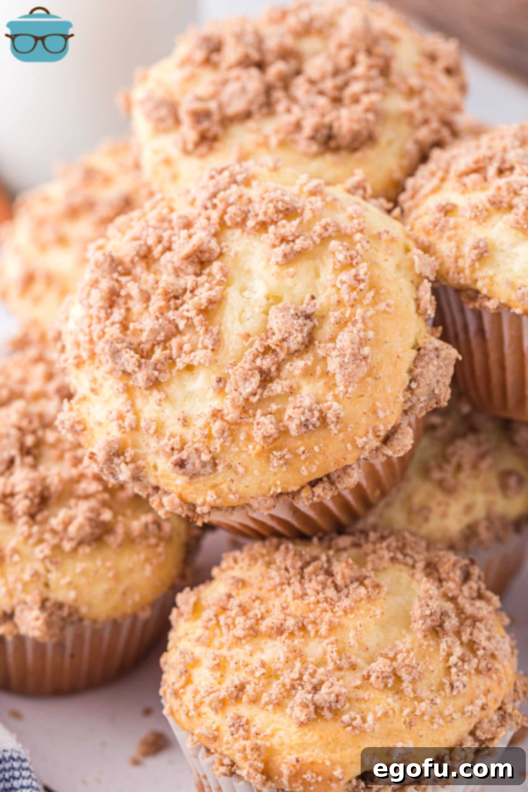 Looking down on a few Cinnamon Streusel Muffins, showcasing their golden crumb topping.