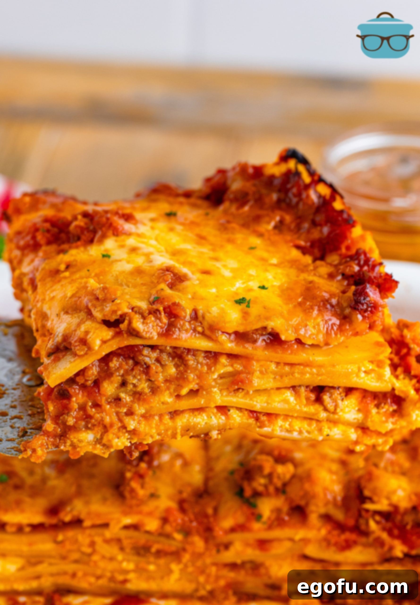 Cozy Lasagna Dinner for Two 11 A perfectly portioned serving of Lasagna for Two, elegantly presented on a white plate, showcasing its distinct layers of pasta, meat sauce, and creamy cheese, ready to be savored.