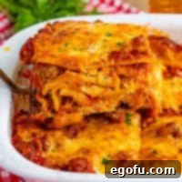 Cozy Lasagna Dinner for Two 12 A serving utensil getting a serving of Lasagna for Two.