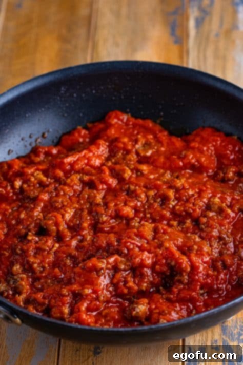 Cozy Lasagna Dinner for Two 15 Marinara sauce and ground sausage in a skillet.