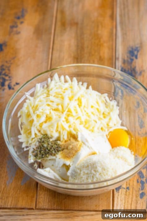 Cozy Lasagna Dinner for Two 16 ricotta cheese, egg, parmesan cheese, mozzarella cheese, Italian seasoning, garlic powder in a bowl.