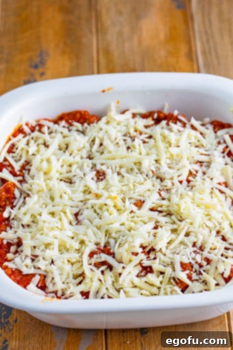 Cozy Lasagna Dinner for Two 22 Mozzarella cheese on top of layered lasagna in a casserole dish.