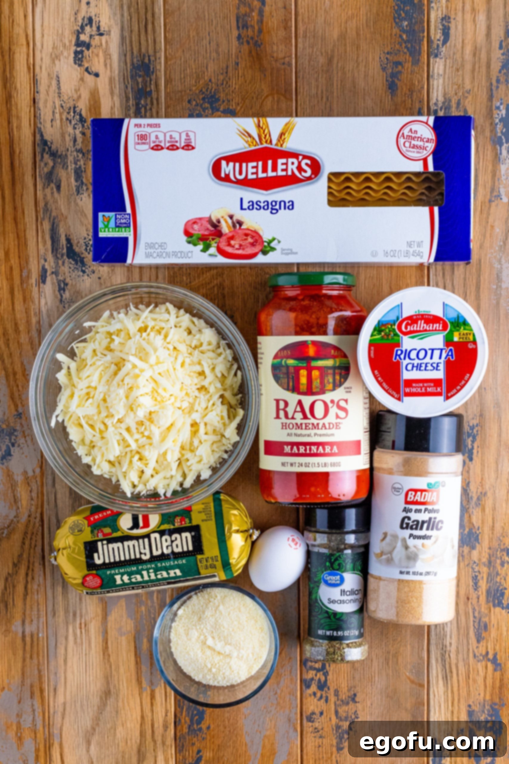 Cozy Lasagna Dinner for Two 4 A vibrant flat lay of all the Lasagna for Two ingredients: lasagna noodles, shredded mozzarella cheese, rich marinara sauce, creamy ricotta cheese, savory ground Italian sausage, a fresh egg, grated parmesan cheese, aromatic Italian seasoning, and garlic powder, beautifully arranged.