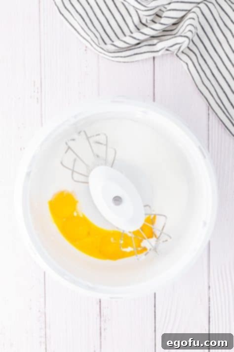 Egg yolks and sugar in a mixing bowl.