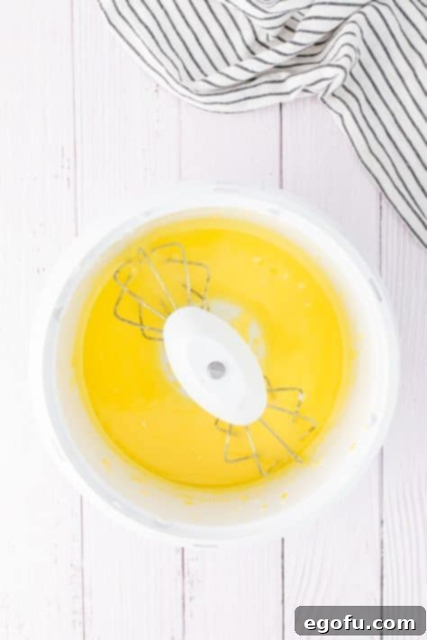 Melted butter being added to a lemon cake mix.